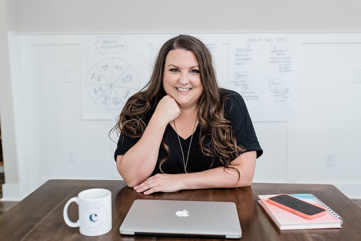 Emily Conley of Emily Writes Well who is a Creative Copywriter for small business owners poses for her branding photos with Dolly DeLong Photography