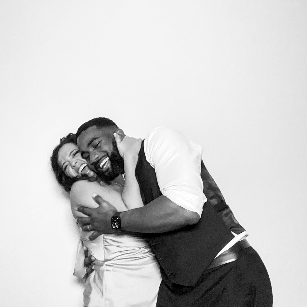 2 guests posing against a white backdrop for a b&w kardashian style selfie pod rental in cotswolds, at hyde house