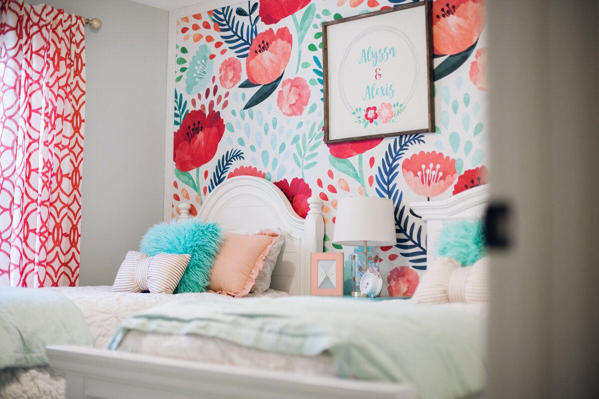 a bed with pink and blue bedding