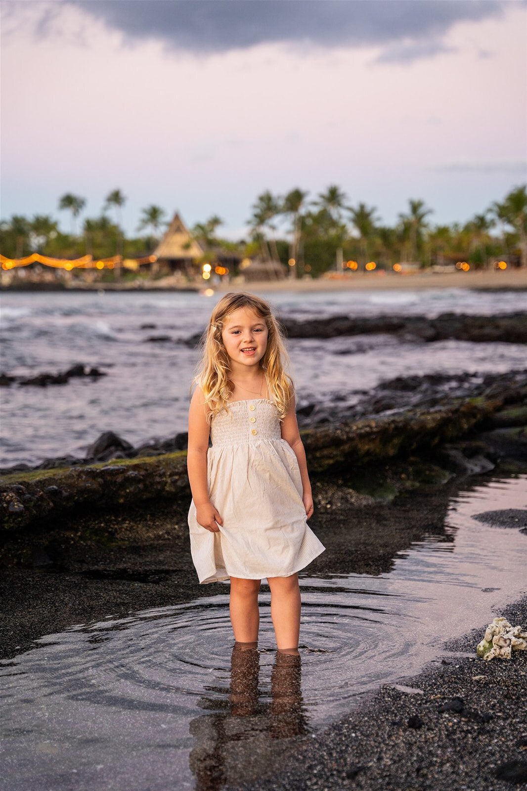 Girl smiling in the ocean in Kona, by one of the best big island family photographers
