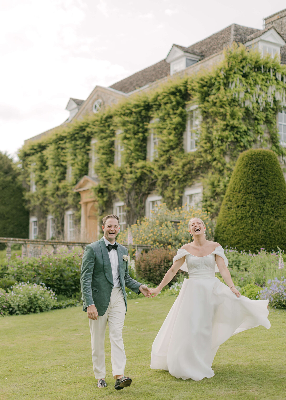 chloe-winstanley-weddings-cotswolds-cornwell-manor-monique-lhuillier-bride-kingsman-suit-couple-laughing