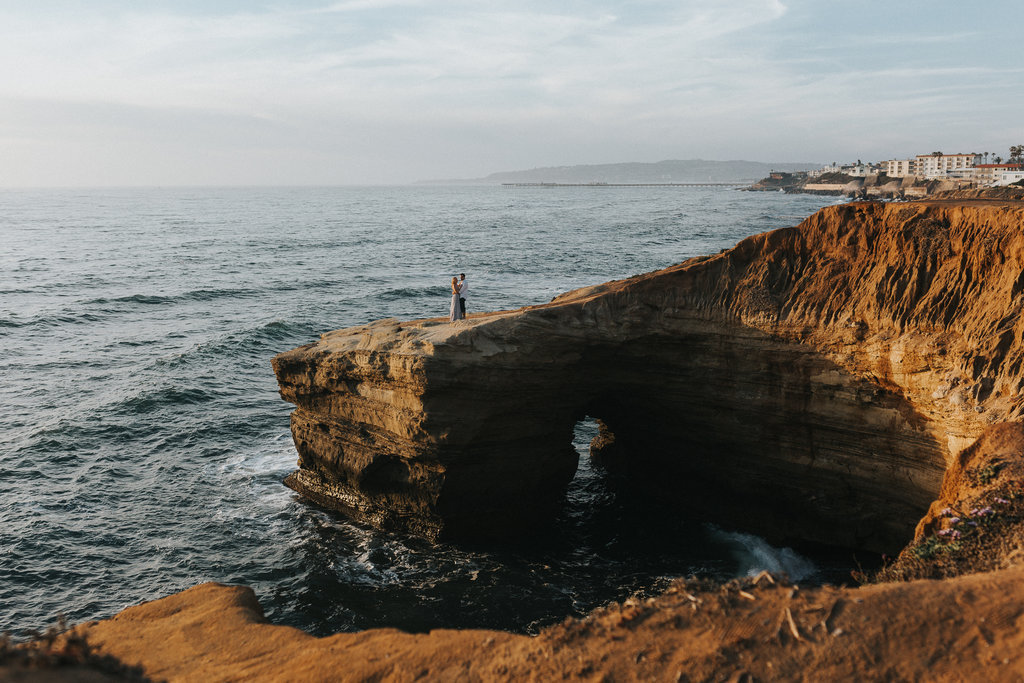 In love couple during their engagement session in San Diego California at Sunset  Cliffs