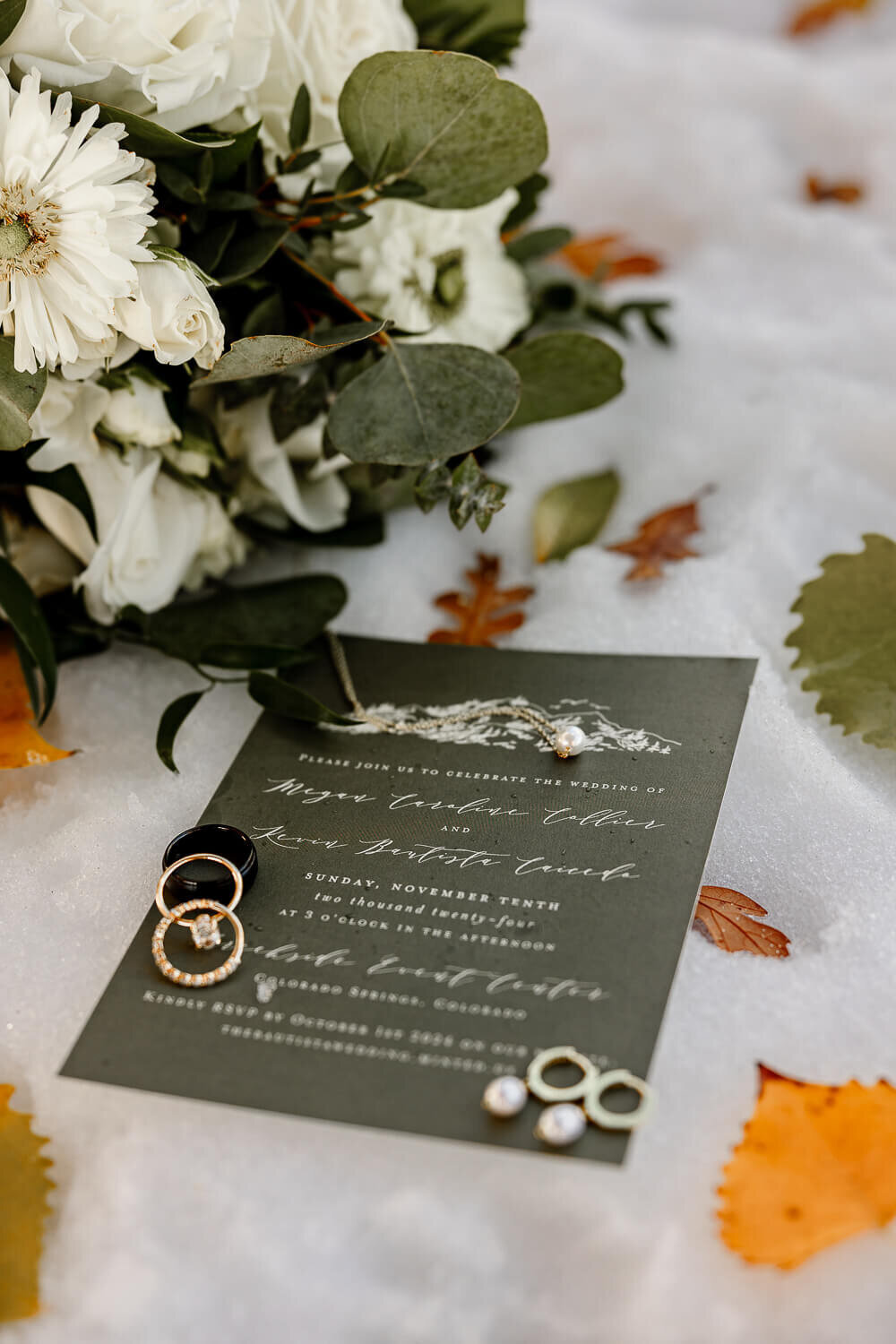 Close-up of wedding rings on the wedding invitation, styled by Colorado Springs Wedding Photographer, Michelle Betz Photography.