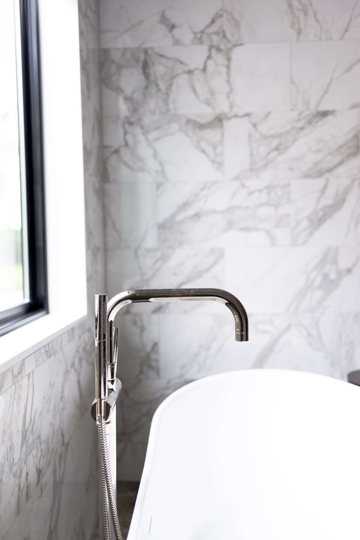 oyster creek studios building belt new build marble wall and free standing tub faucet in bathroom