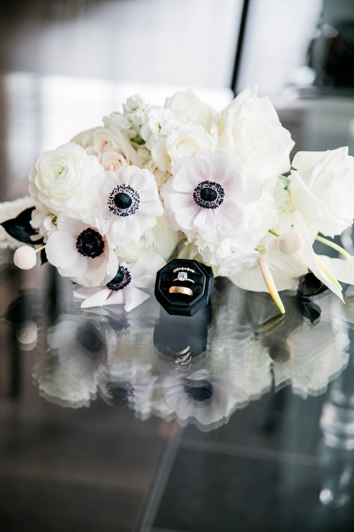 bouquet and rings on glass table
