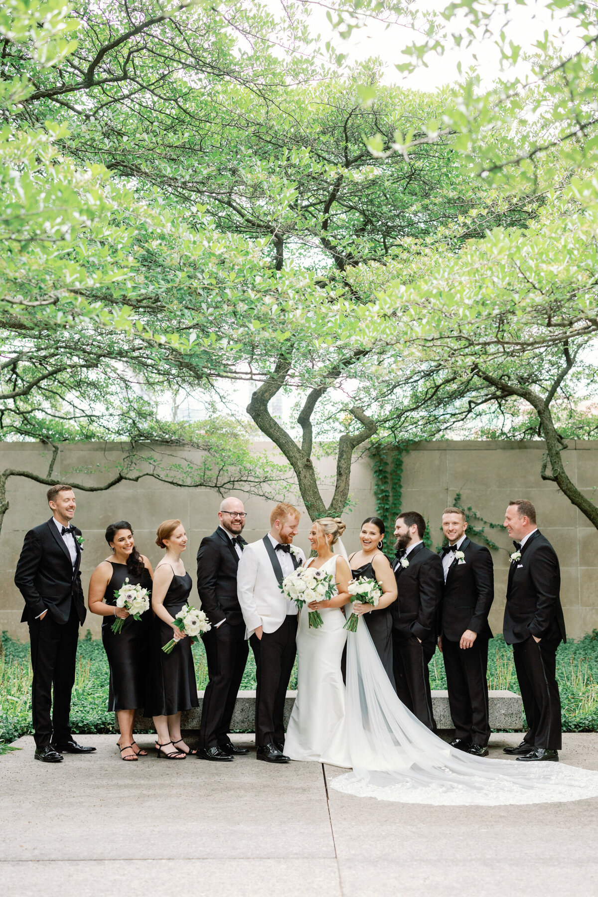 A wedding party poses for a photo in the South Garden at the Art Institute of Chicago