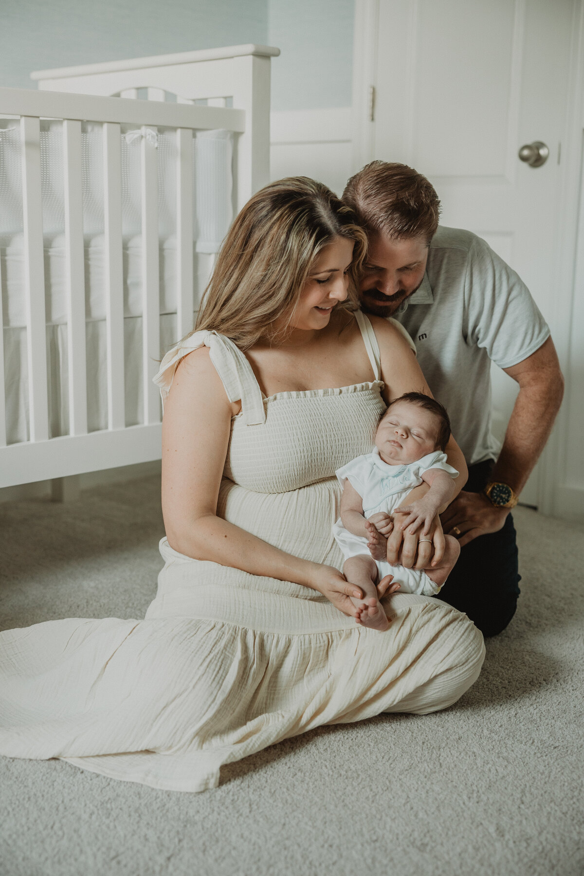 parents-hold-newborn-in-nursery