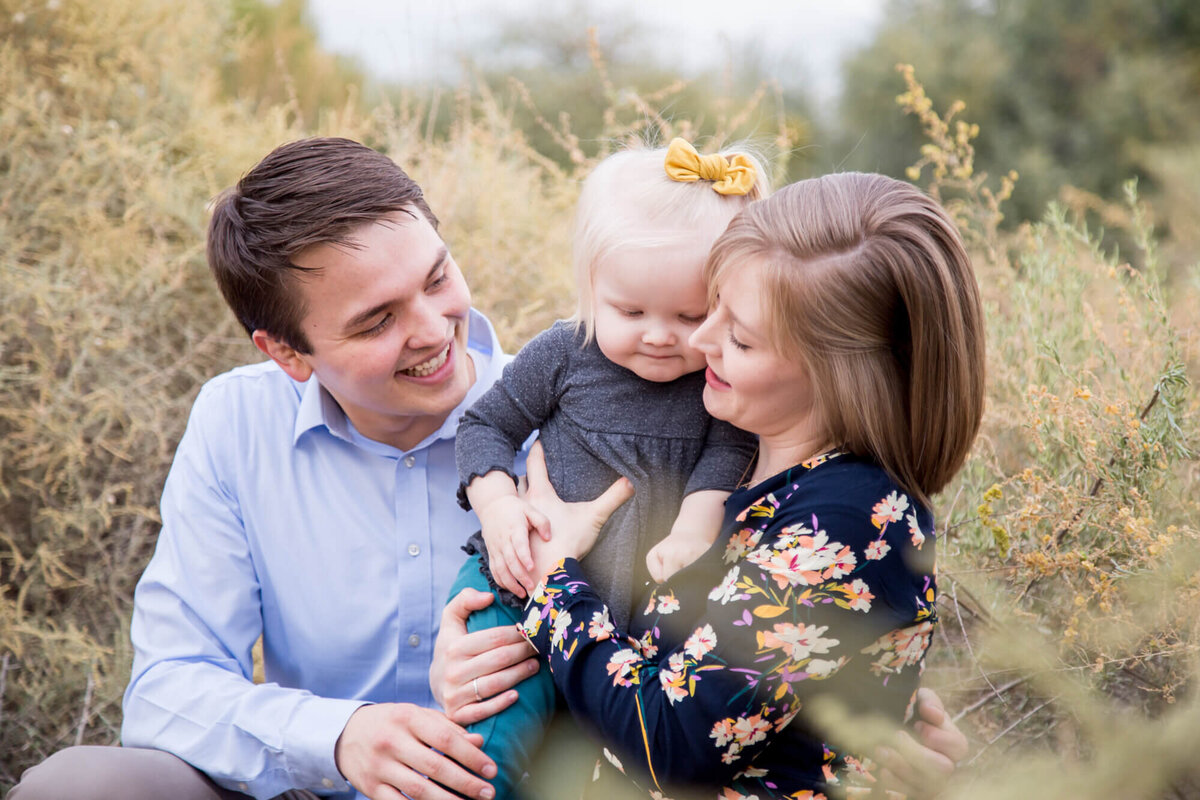 blonde Family snuggling together during  desert family portrait session with Jessica Bowles