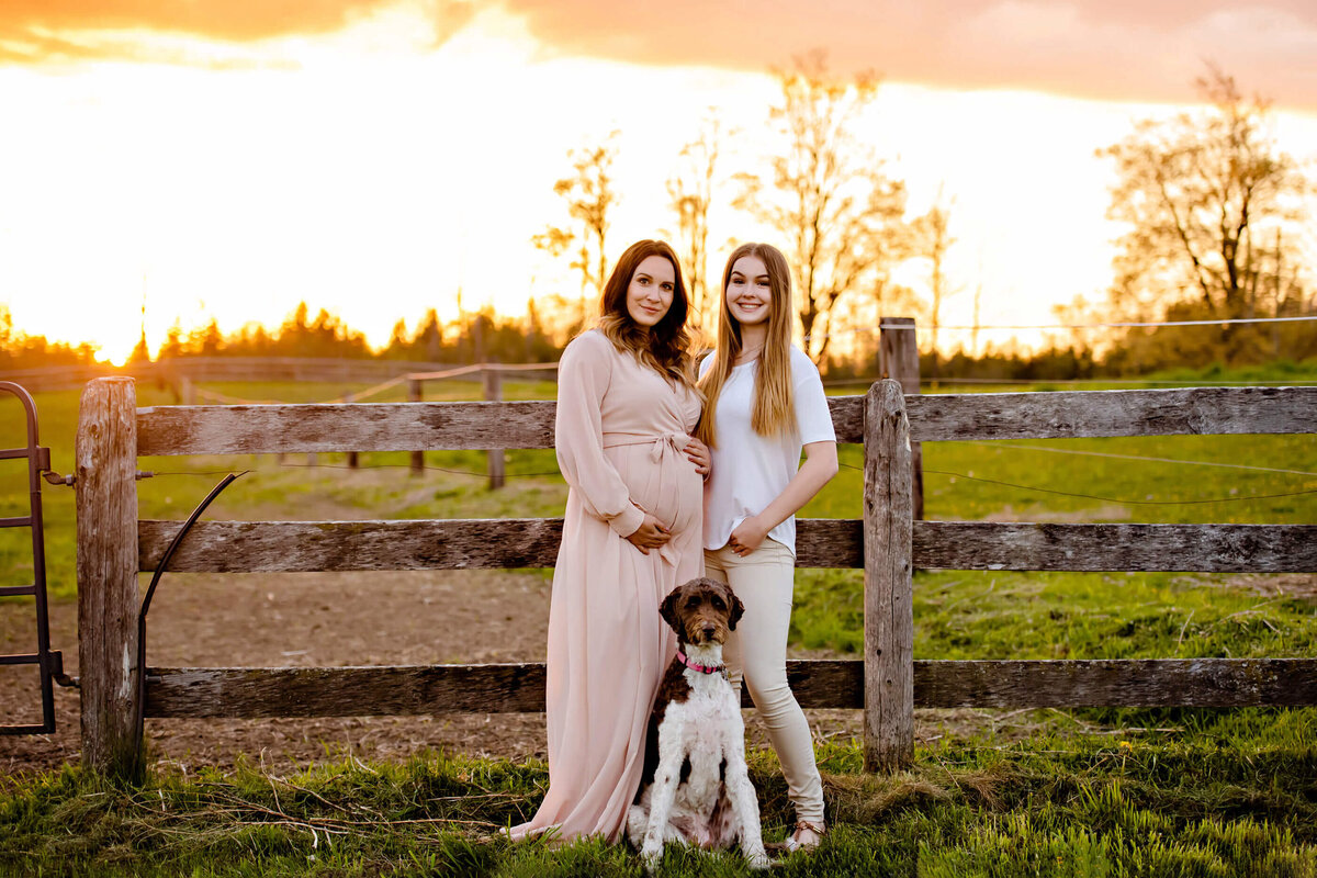 mom with teenage daughter and dog for their outdoor summer maternity photography session in Burlington, ON