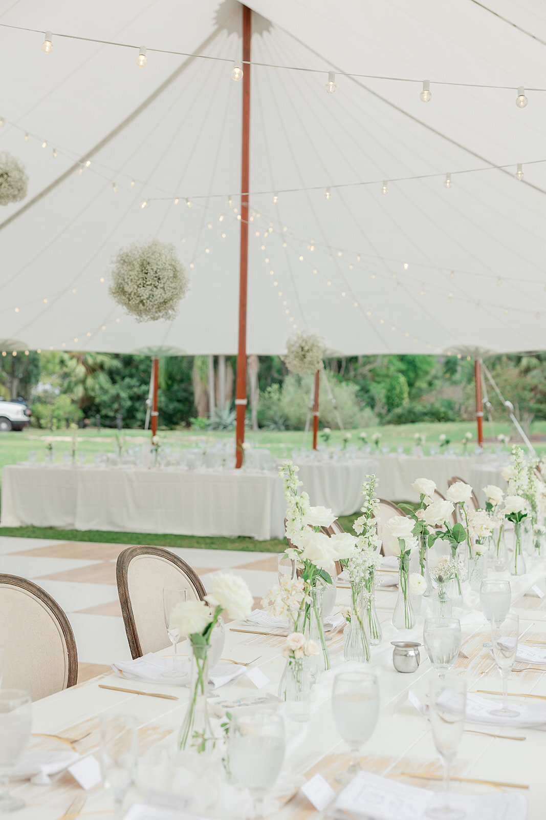 Beautiful table setting for a wedding reception surrounded by white roses 
