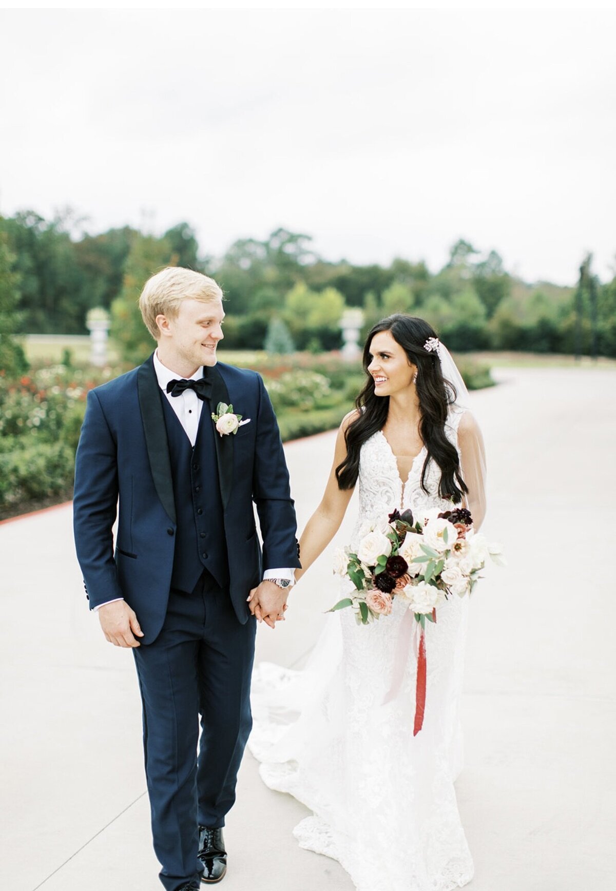 Wedding Photography, bride and groom smiling at each other walking hand in hand