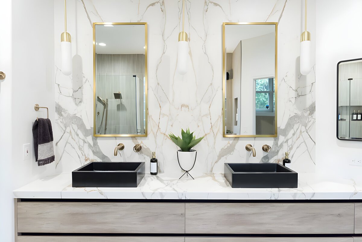 dewine design interiors hotel lux bathroom double black sinks with gold trimmed mirrors