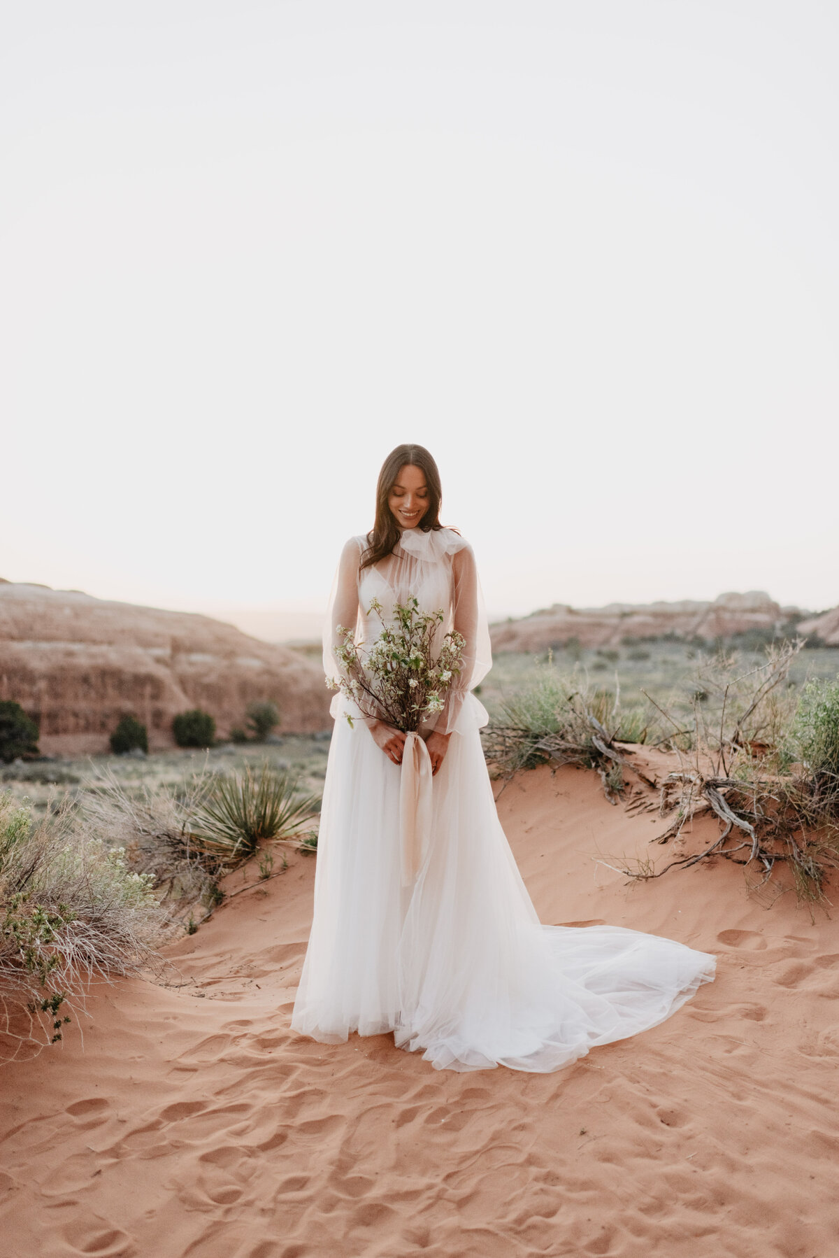 Utah elopement photographer captures bride looking at bouquet