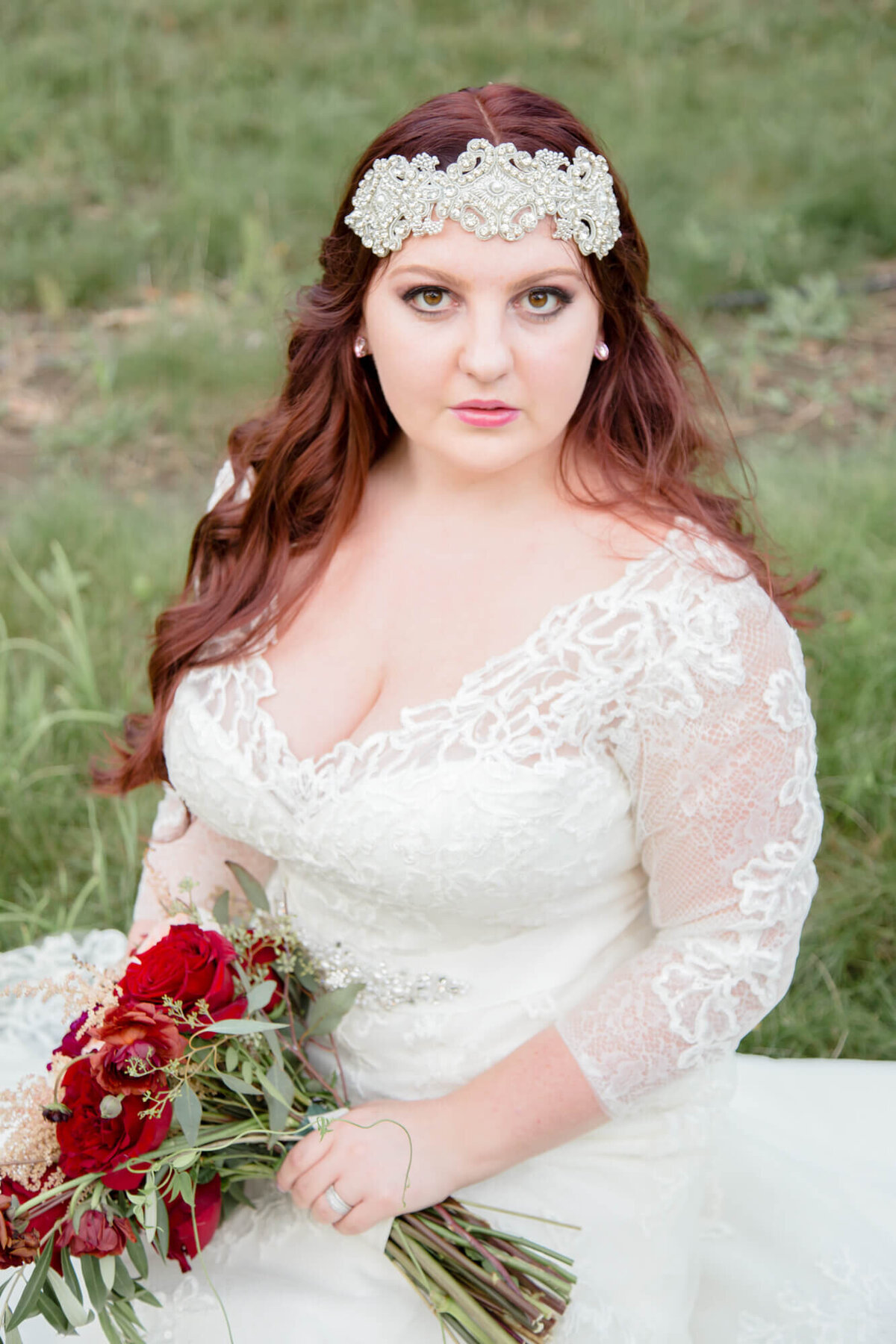 Beautiful red headed bride sits for a portrait with wedding photography pro Jessica Bowles