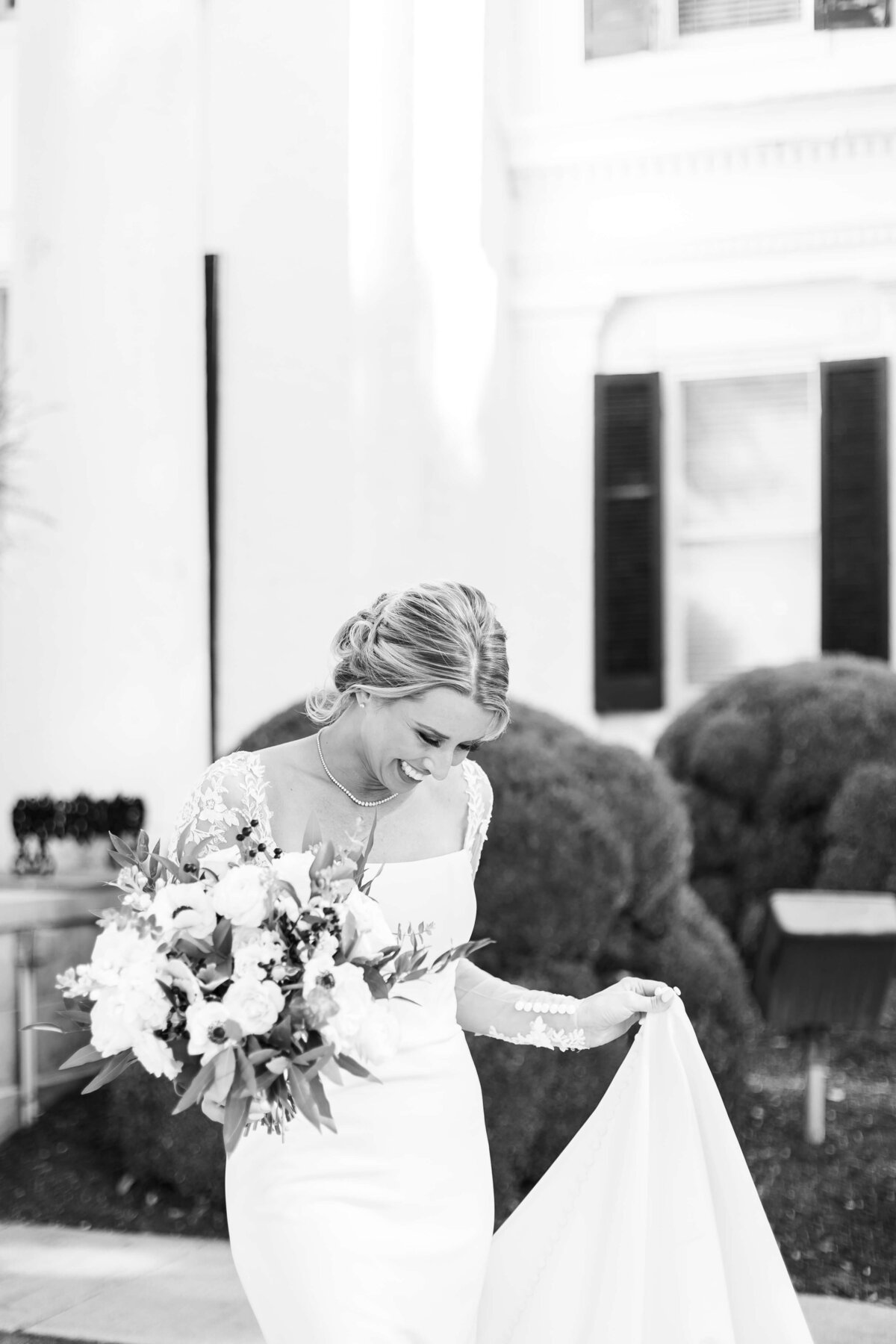 Bride lifting up dress carrying bouquet at The Carrick House Wedding venue in Lexington, KY