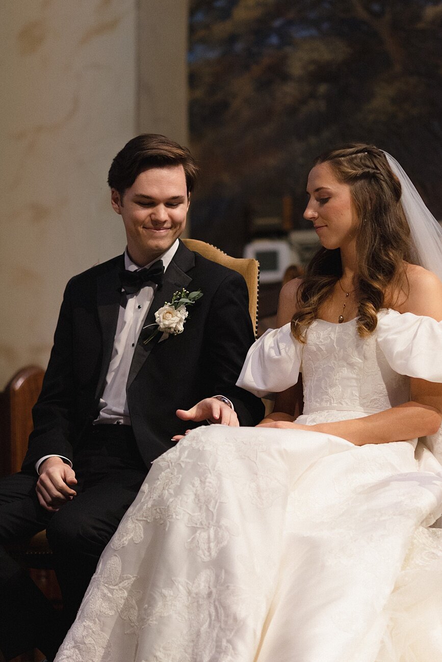 bride and groom hold hands during ceremony
