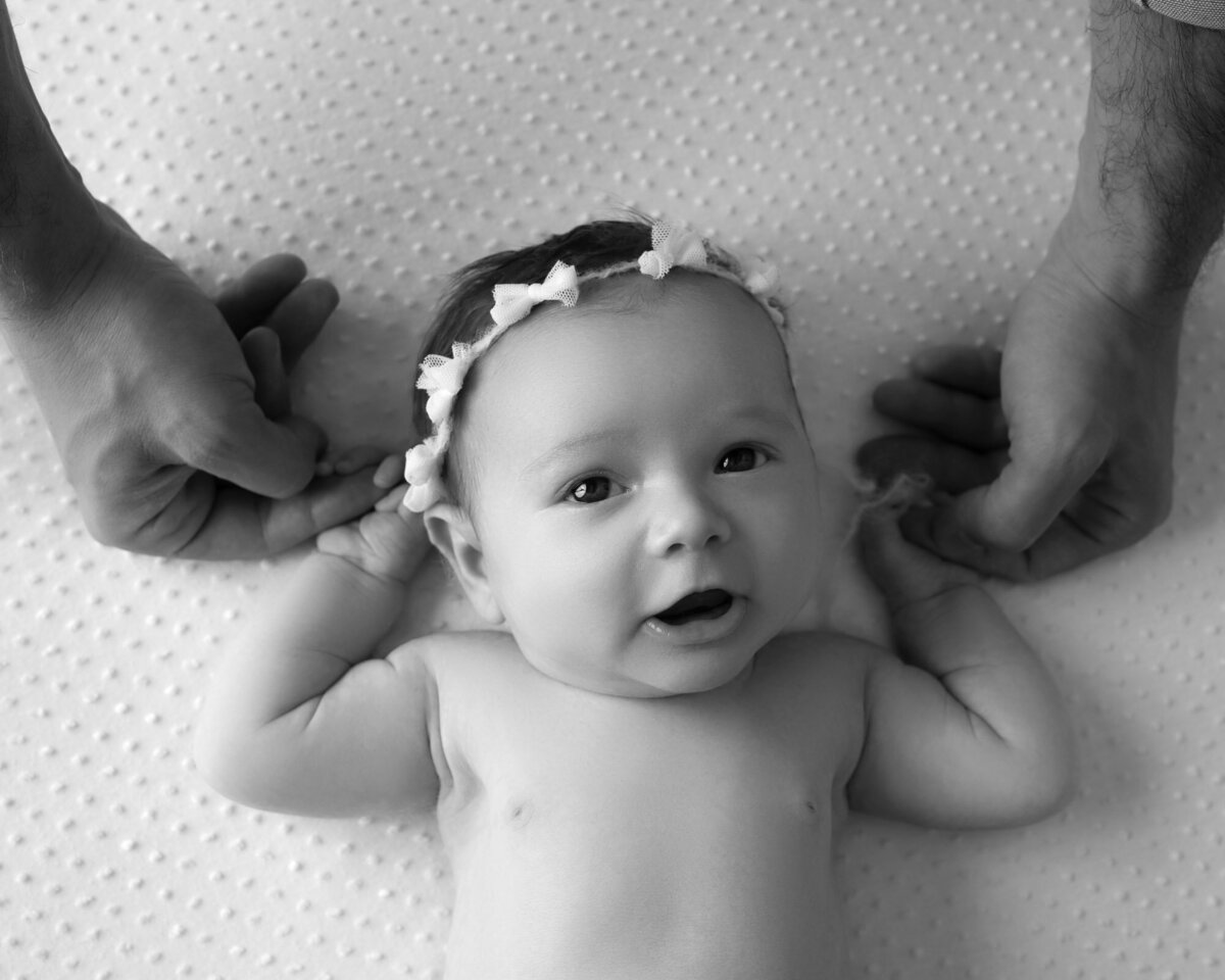 Black white newborn baby angel wings pose Cedar Park artistic photographer