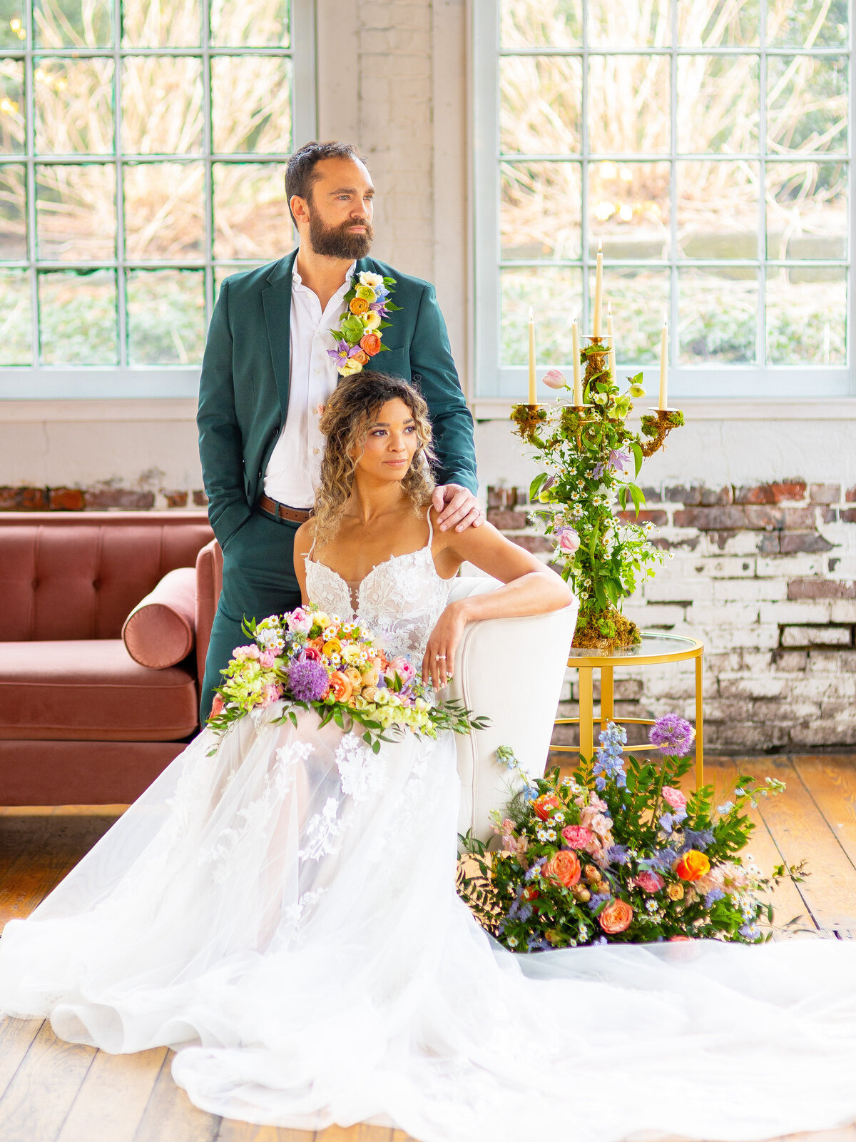 Bride sitting and groom standing behind her