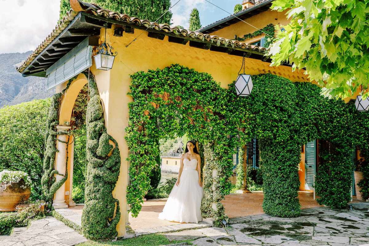 Film photograph of bride walking under ivy covered archways  at her elopement at Villa Cassinella on Lake Como Italy