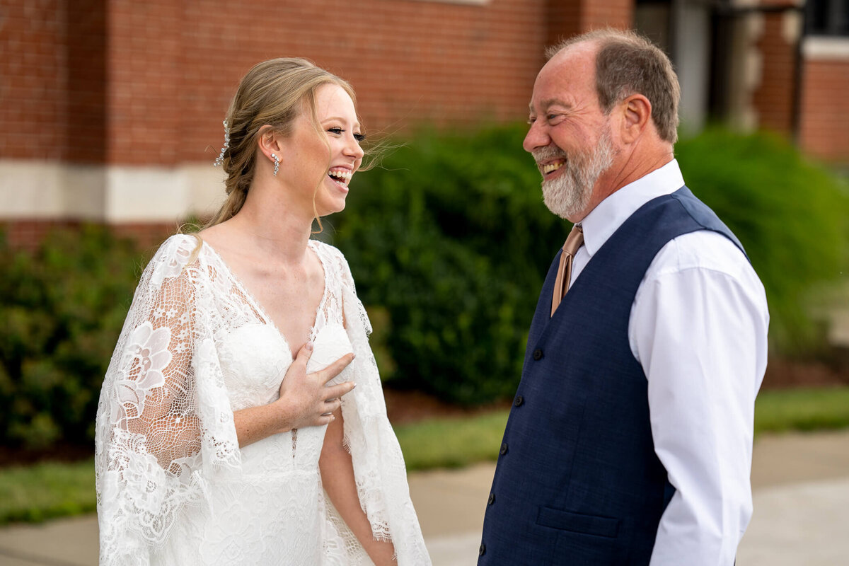 Candid pittbsurgh wedding photography of bride and her father sharing a laugh together after their first look