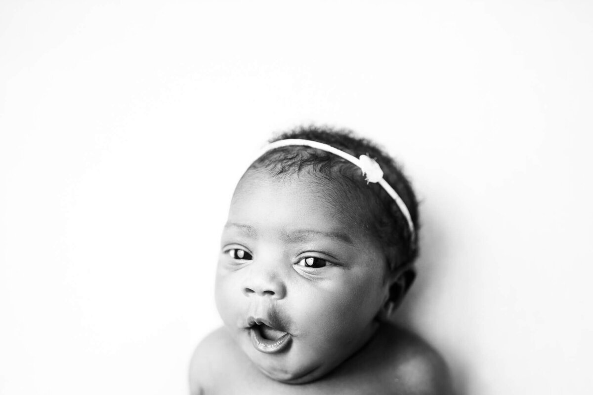 black and white image of awake baby girl's facial expression