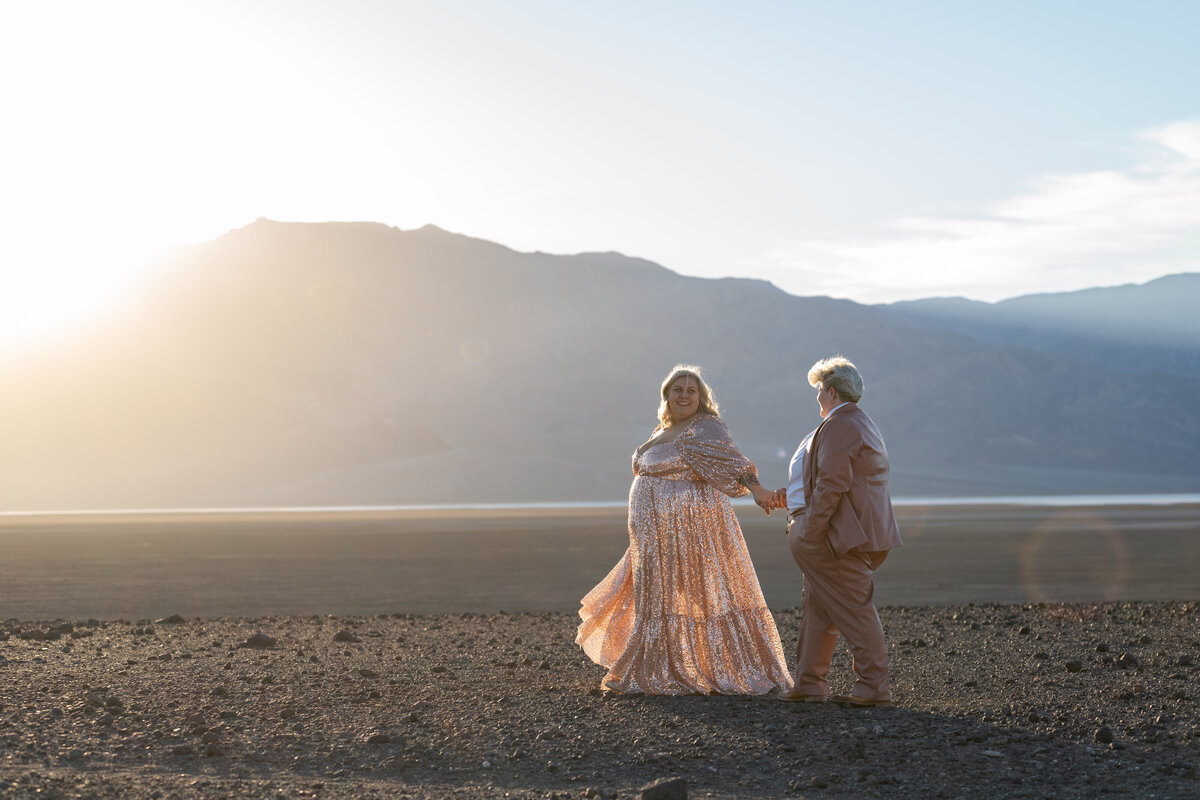 A couple holding hands and walking together in the desert