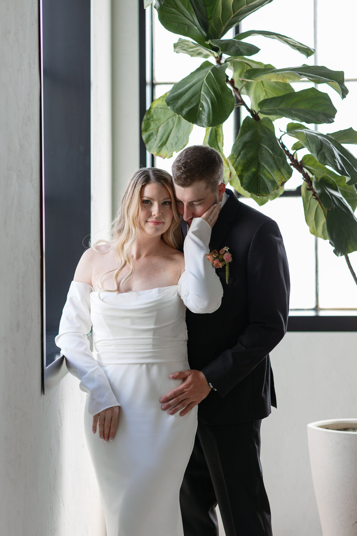 A stylish couple's portrait captured in the chic setting of The Tinsmith, showcasing their love against the backdrop of this modern Madison venue.
