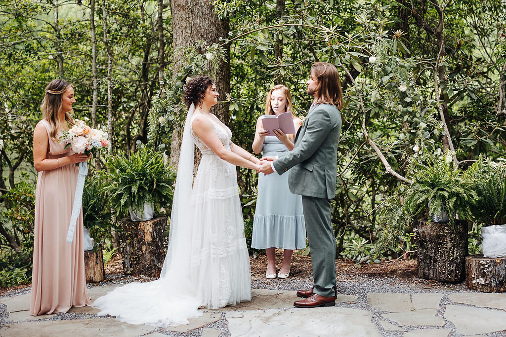 bride and groom holding hands at outdoor wedding ceremony