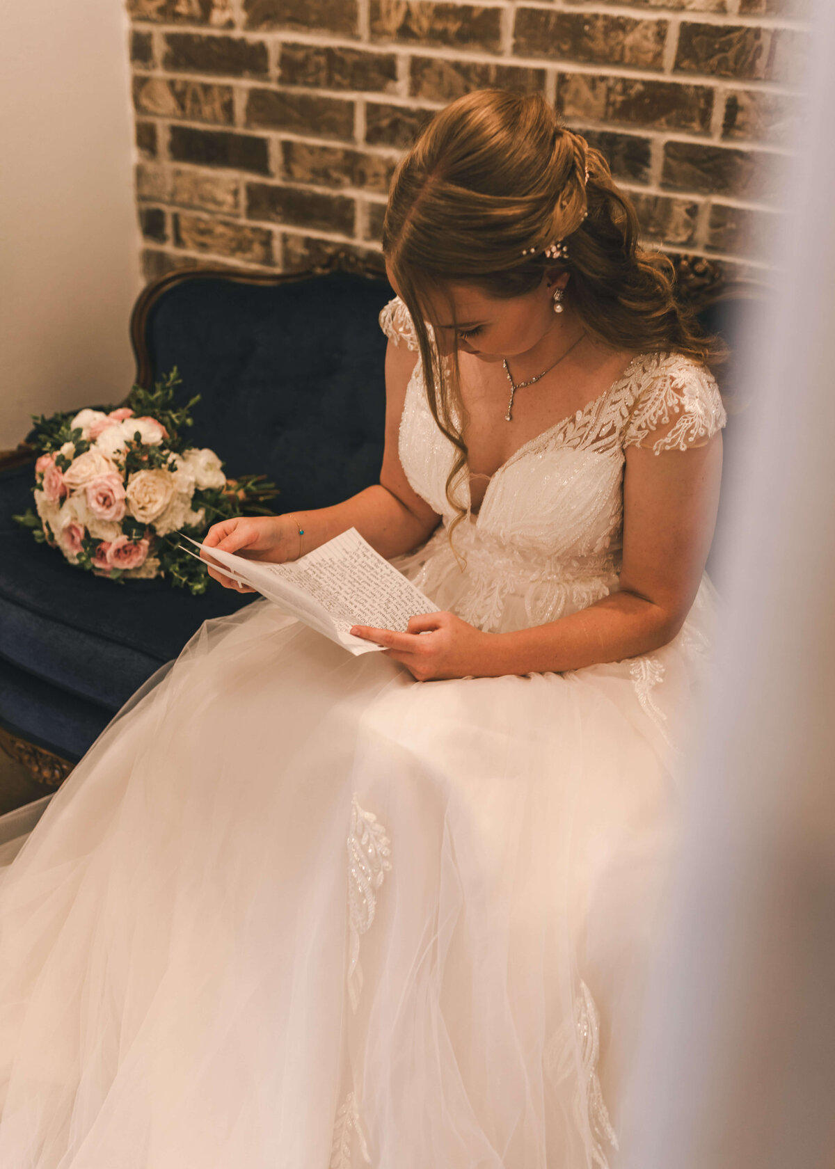 bride reads private letter from groom in bridal suite