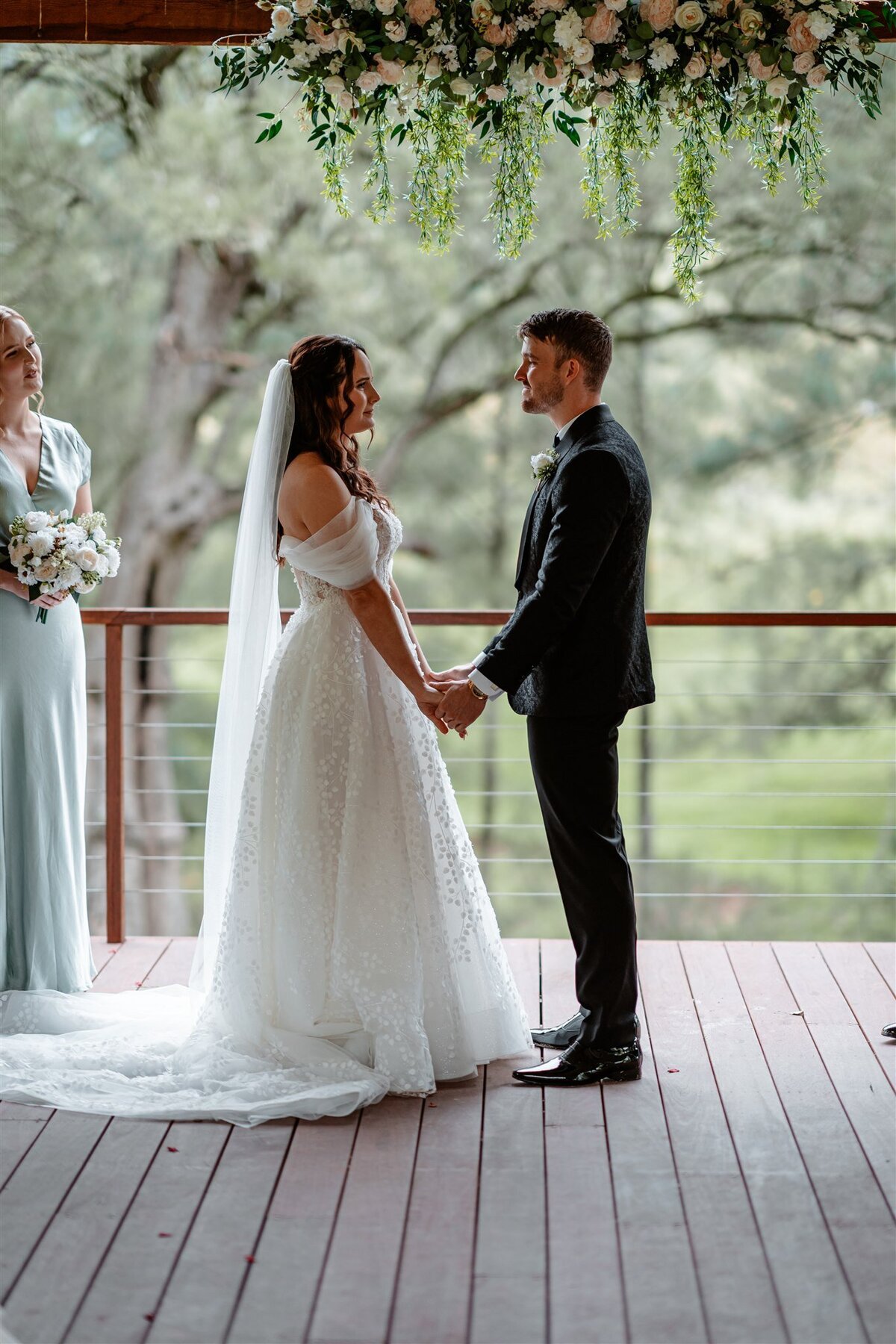 A couple stands lovingly at their ceremony, exchanging vows with heartfelt emotion.