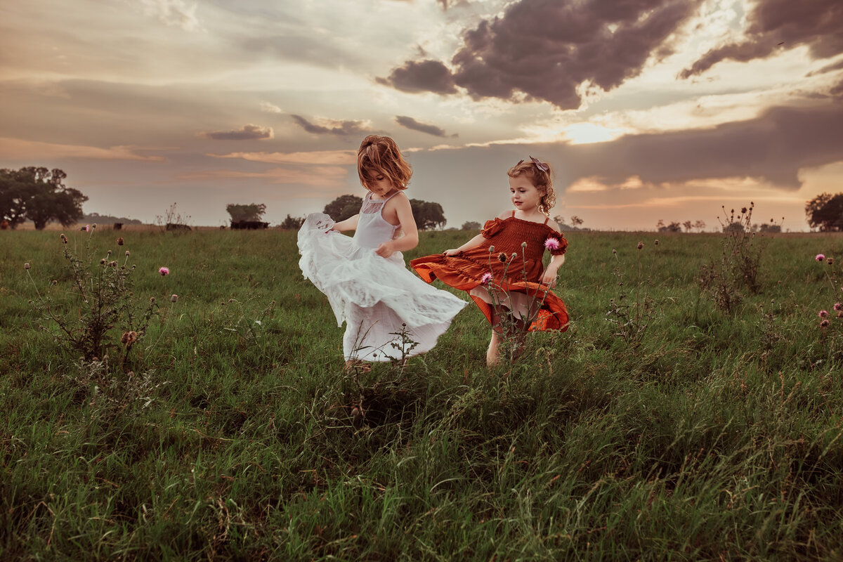 siblings-twirling-dresses-in-sunset-meadow