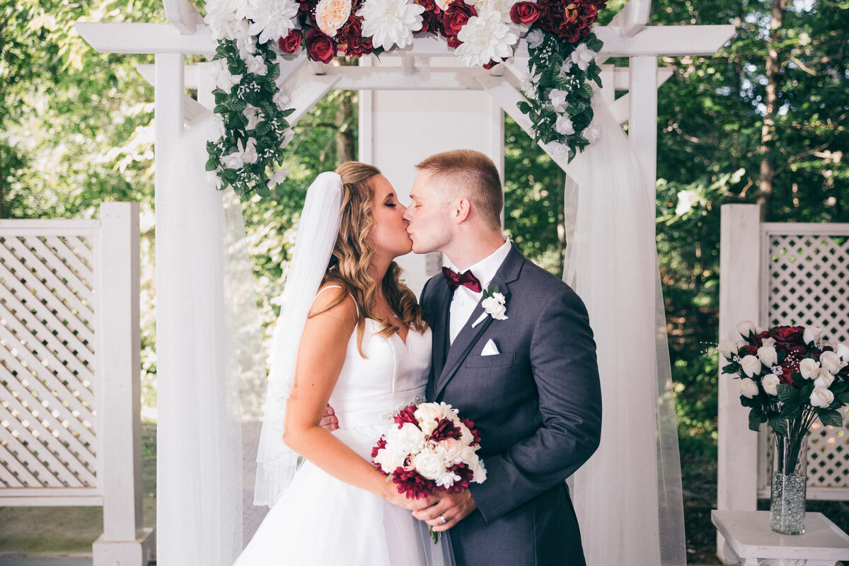 Bride and Groom kiss at Westfields Golf Club located in Clifton, Virginia