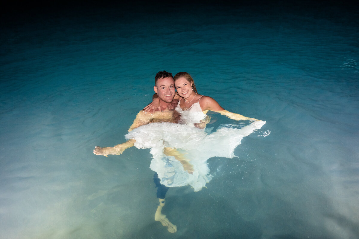 bride and groom in pool at las palomas resort