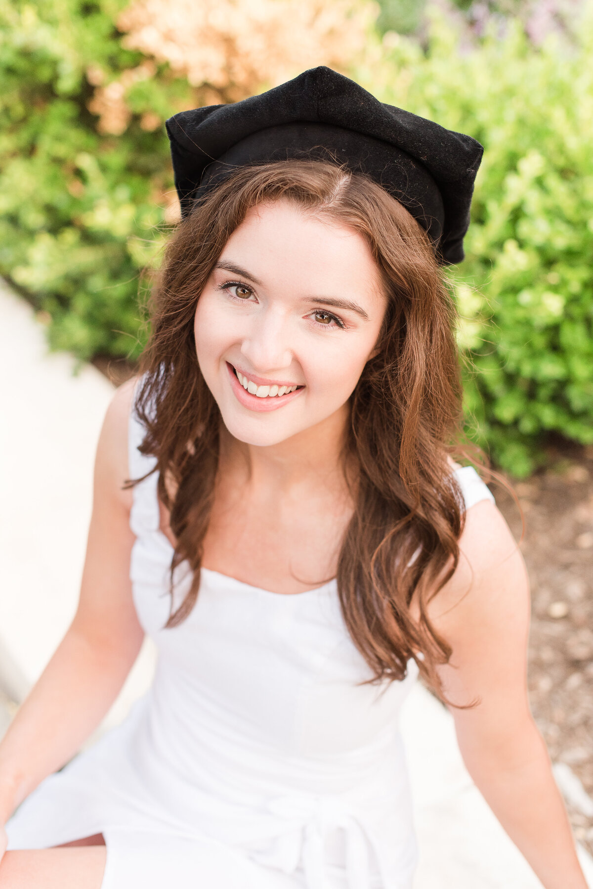 grad with black cap and white dress