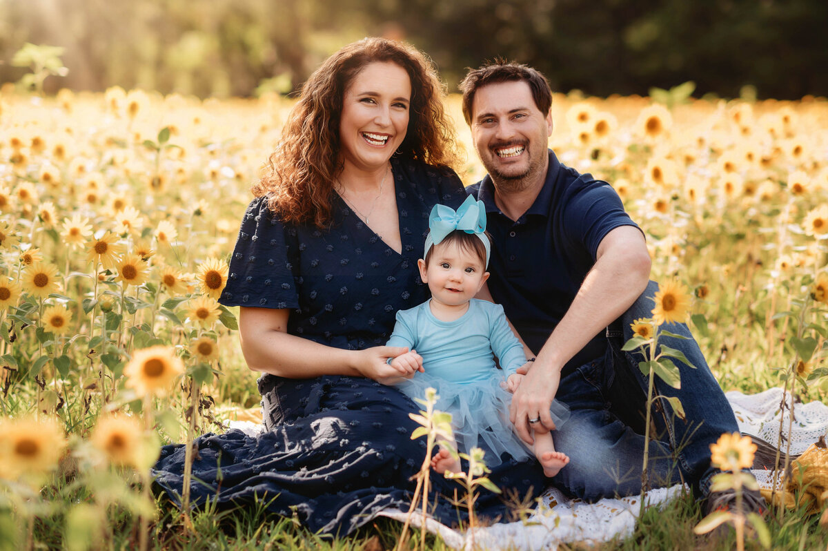 Parents embrace their baby during baby photoshoot in Charleston, SC.