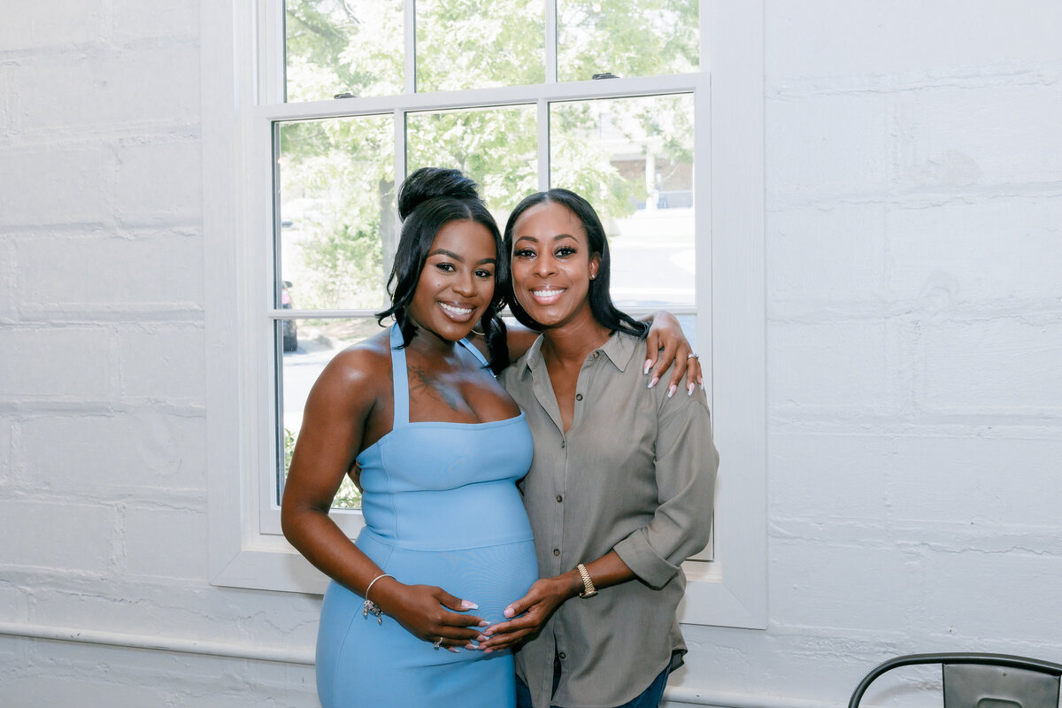 Mommy-to-be poses with attendee at her  baby shower at Upstairs Atlanta.