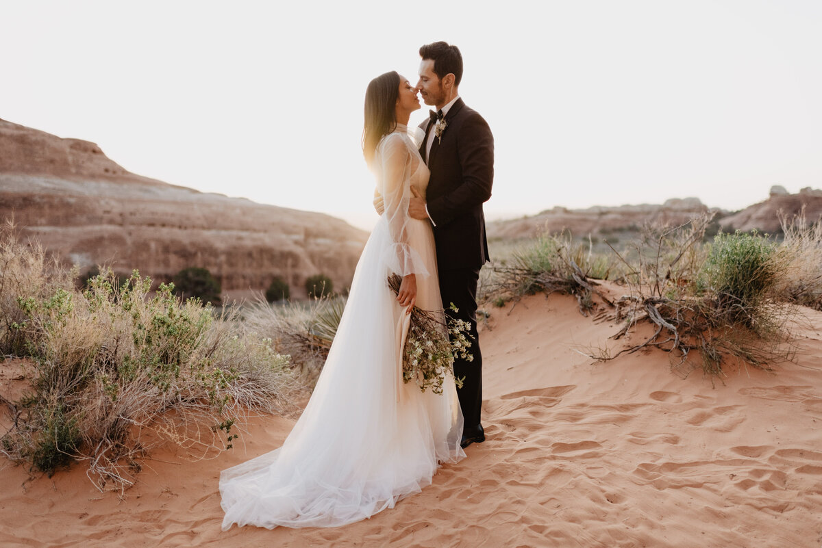 Utah elopement photographer captures couple kissing at sunset