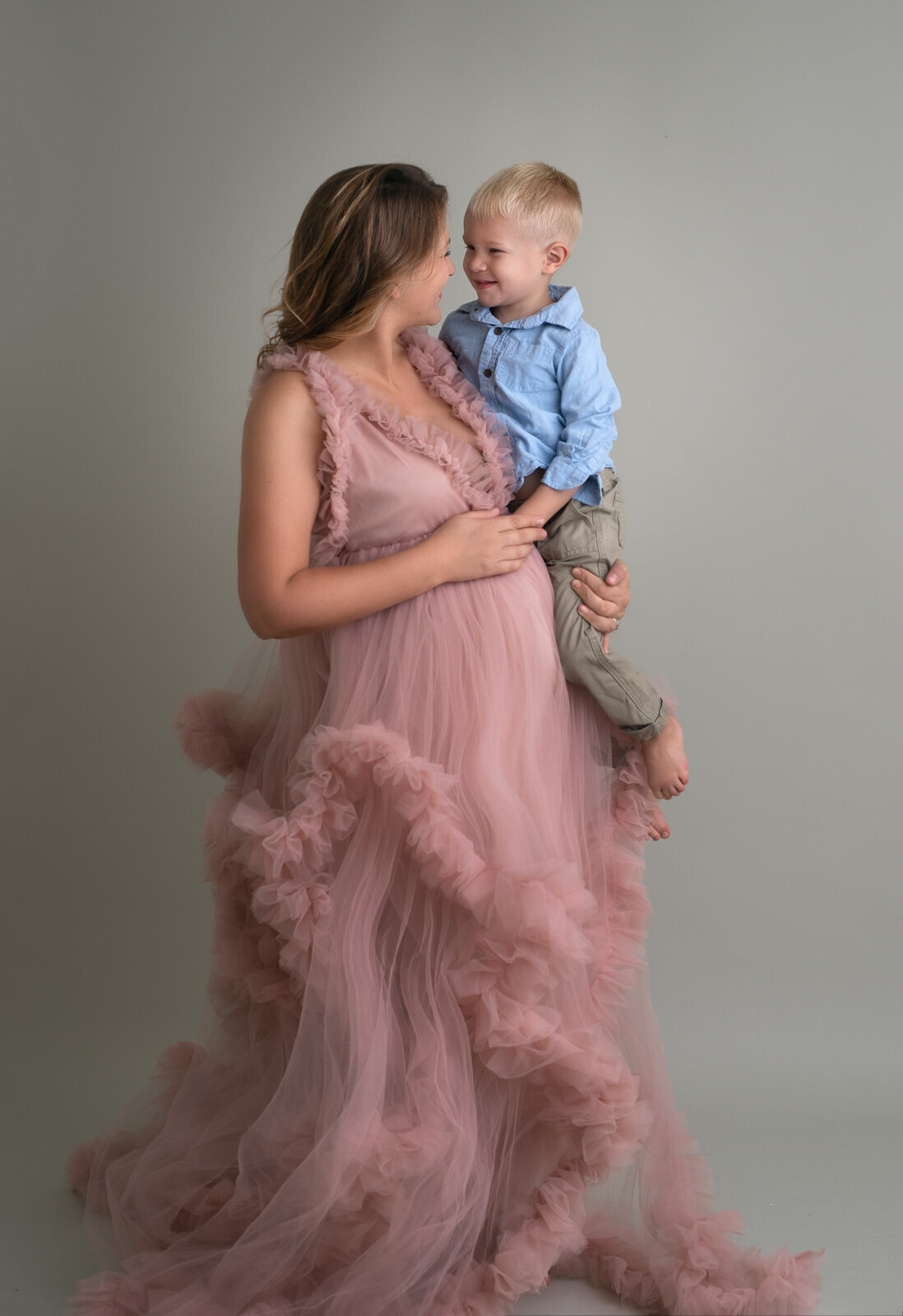 pregnant mom and son at photo studio for maternity  photos