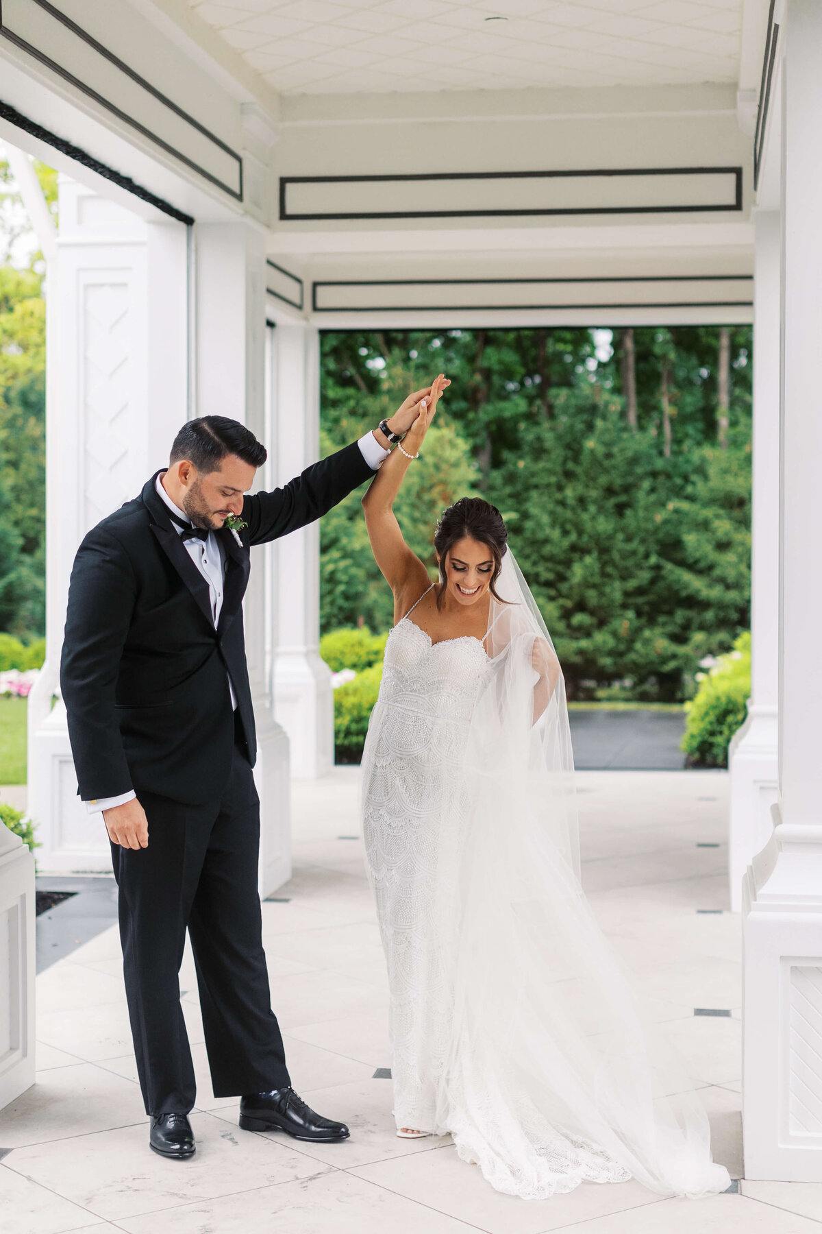 Groom twirls his bride during their First Look at Shadowbrook wedding venue.