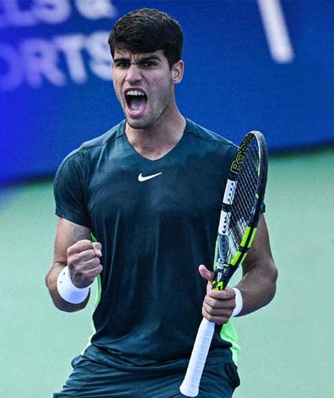 Male tennis player in green shirt passionately shouting after winning a point during United Cup Tennis tournament