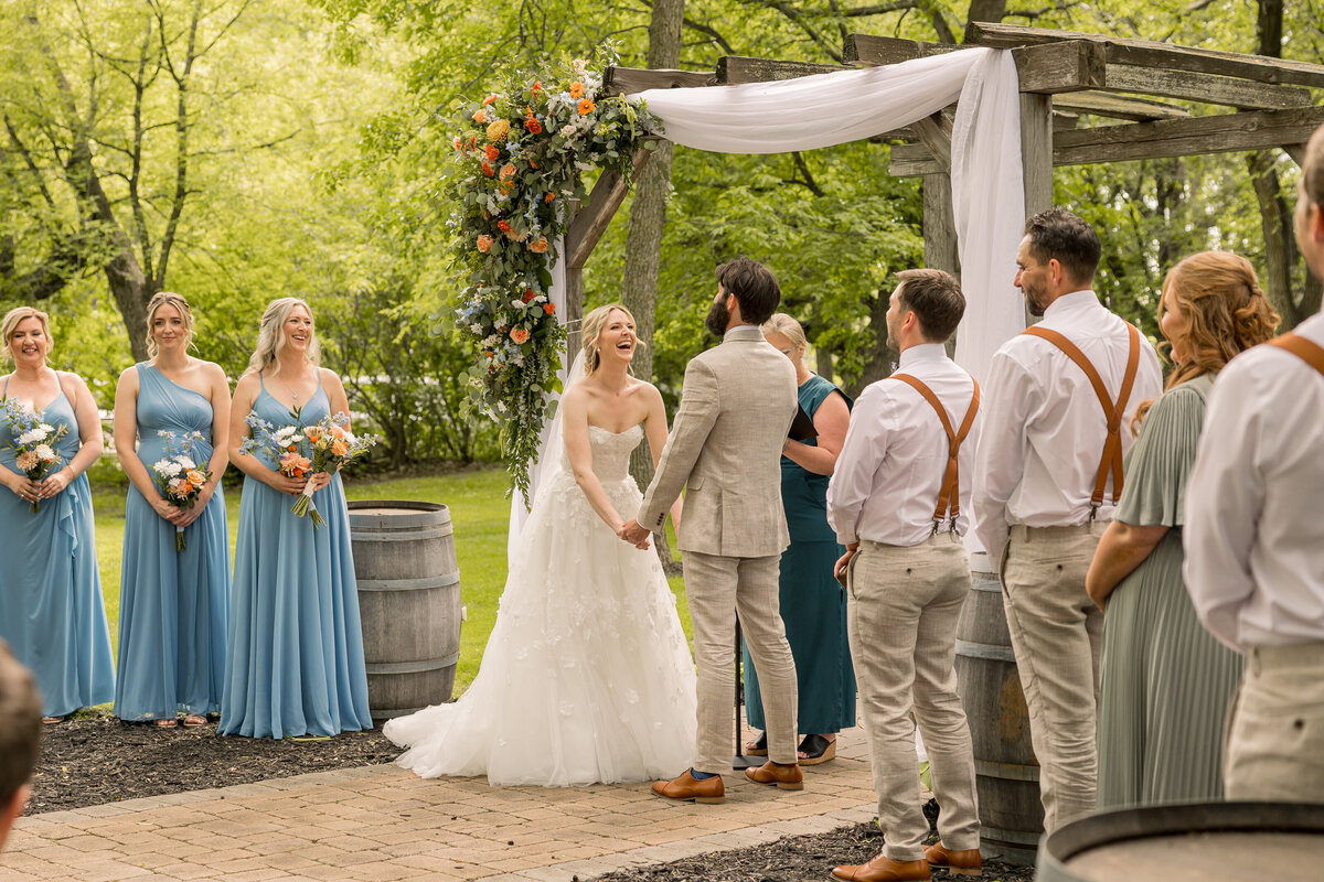 Bride and groom at outdoor ceremony on wedding day at Carlos Creek Winery wedding venue in Alexandria Minnesota