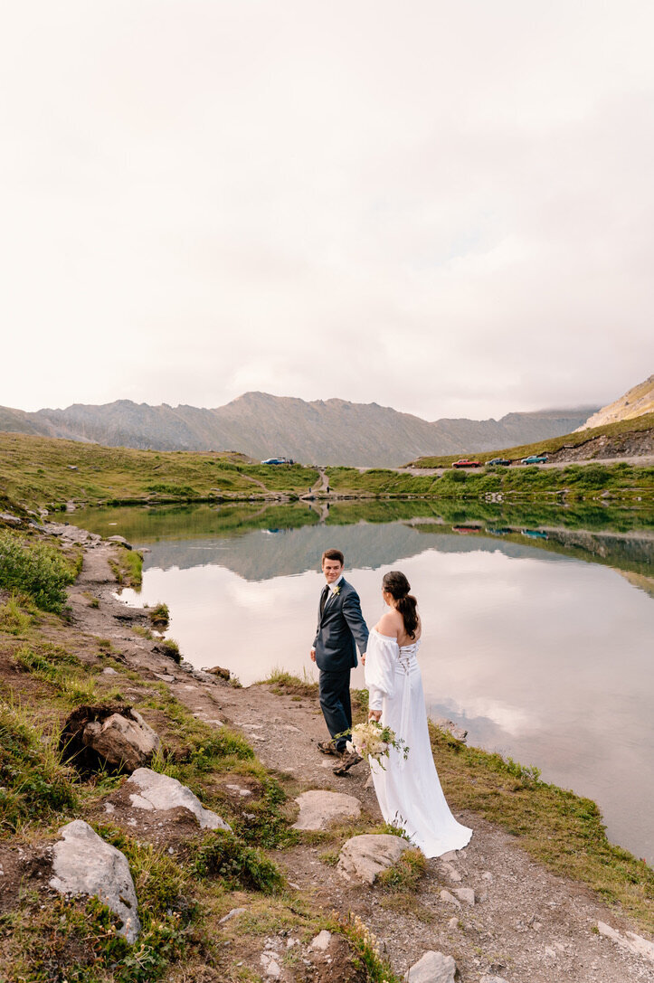 bride and groom walking in the mountains