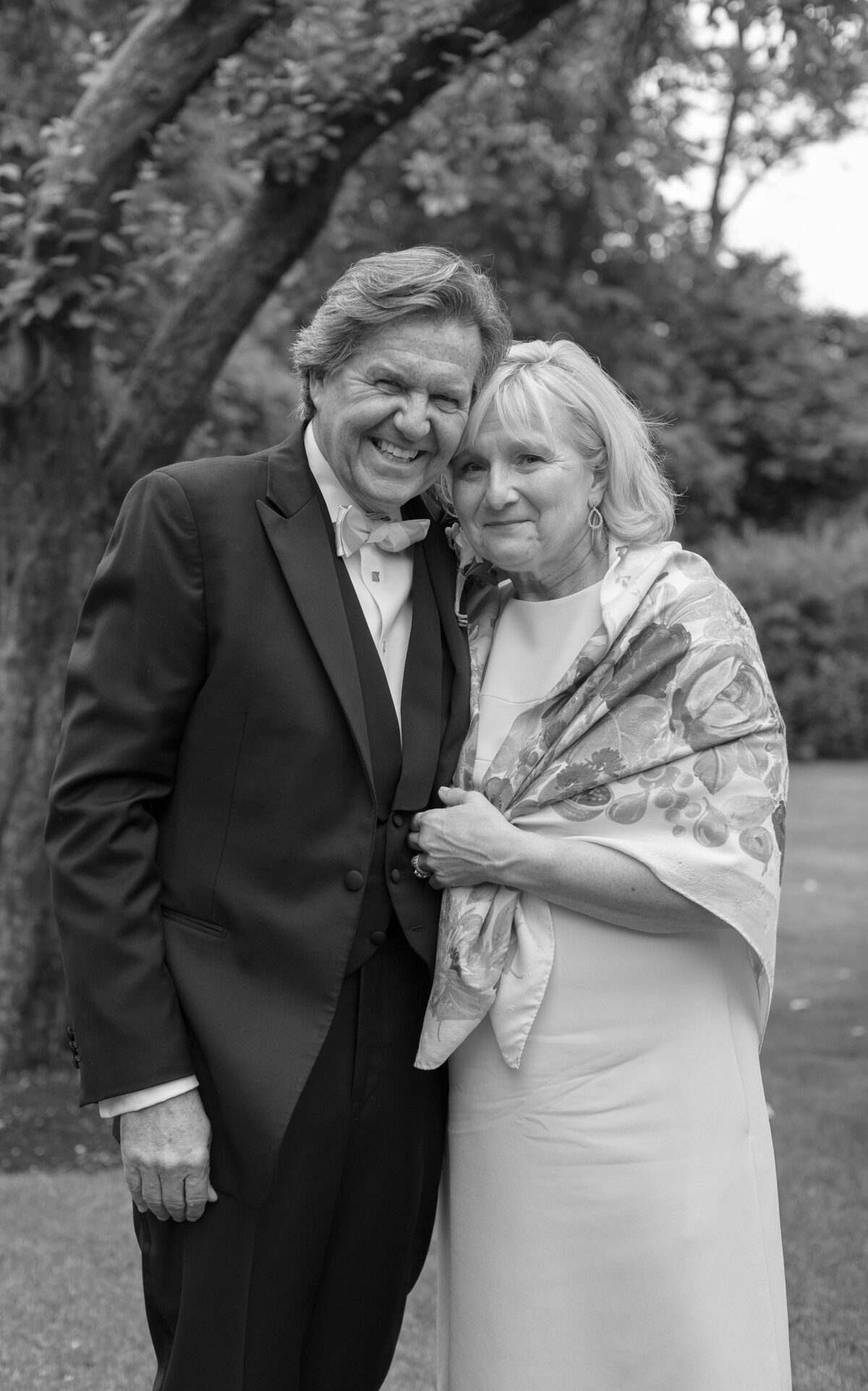 Portrait of parents looking at camera during wedding reception.