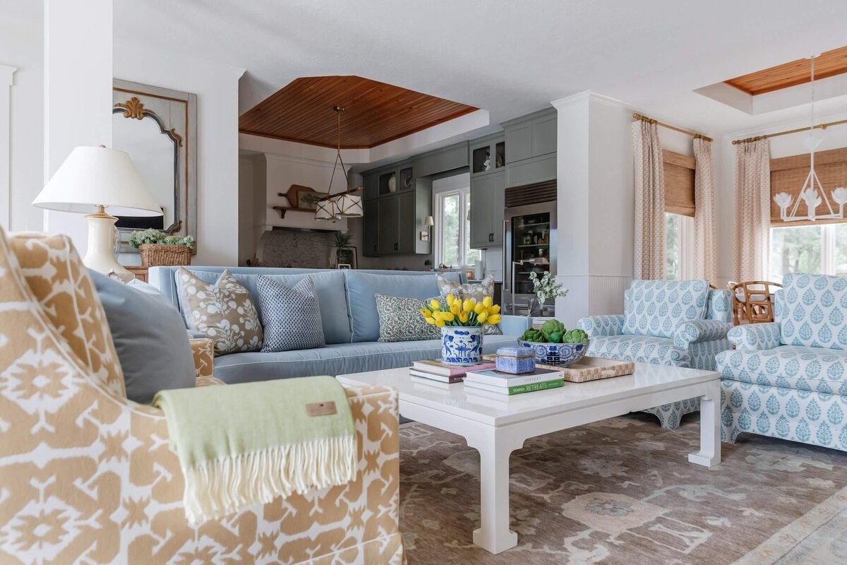 oyster creek studios home on the range light blue armchairs blue sofa and brown loveseat around white coffee table in living room