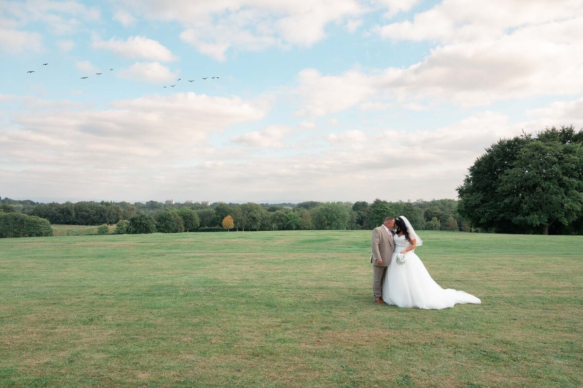 ride and groom forehead to forehead at Heaton Park wedding in Manchester