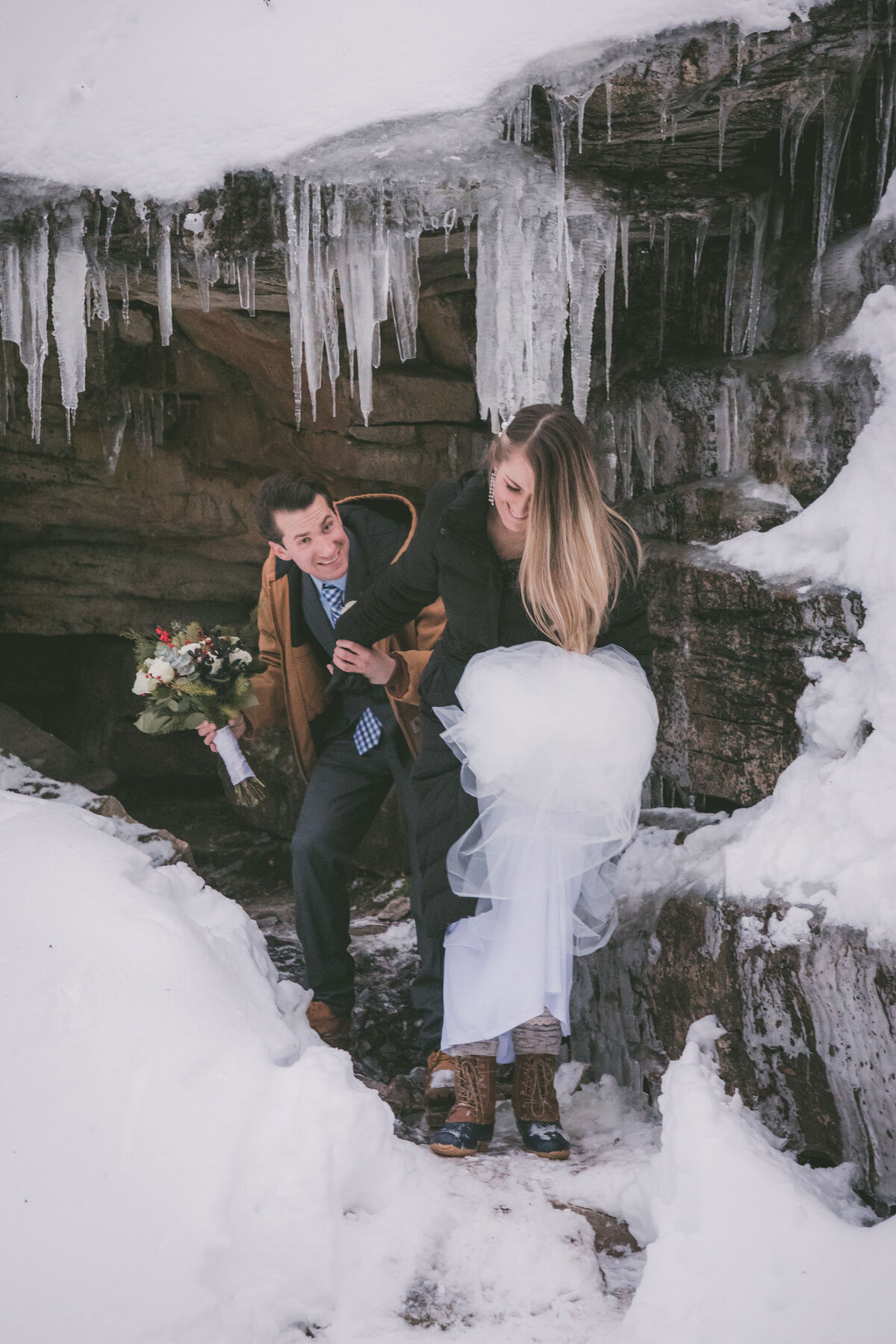 Couple walks out of frozen cave.