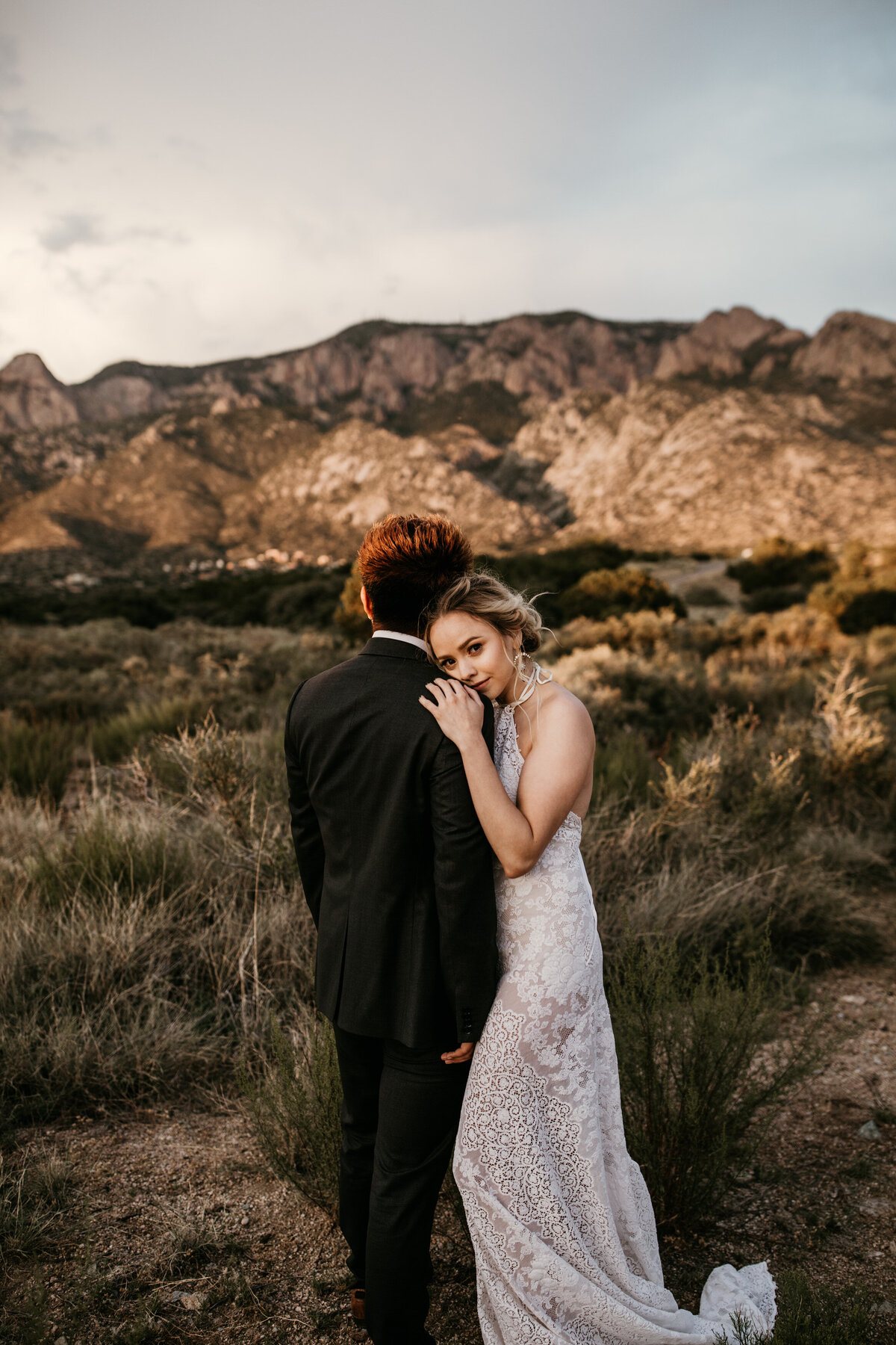 newlyweds standing in the desert