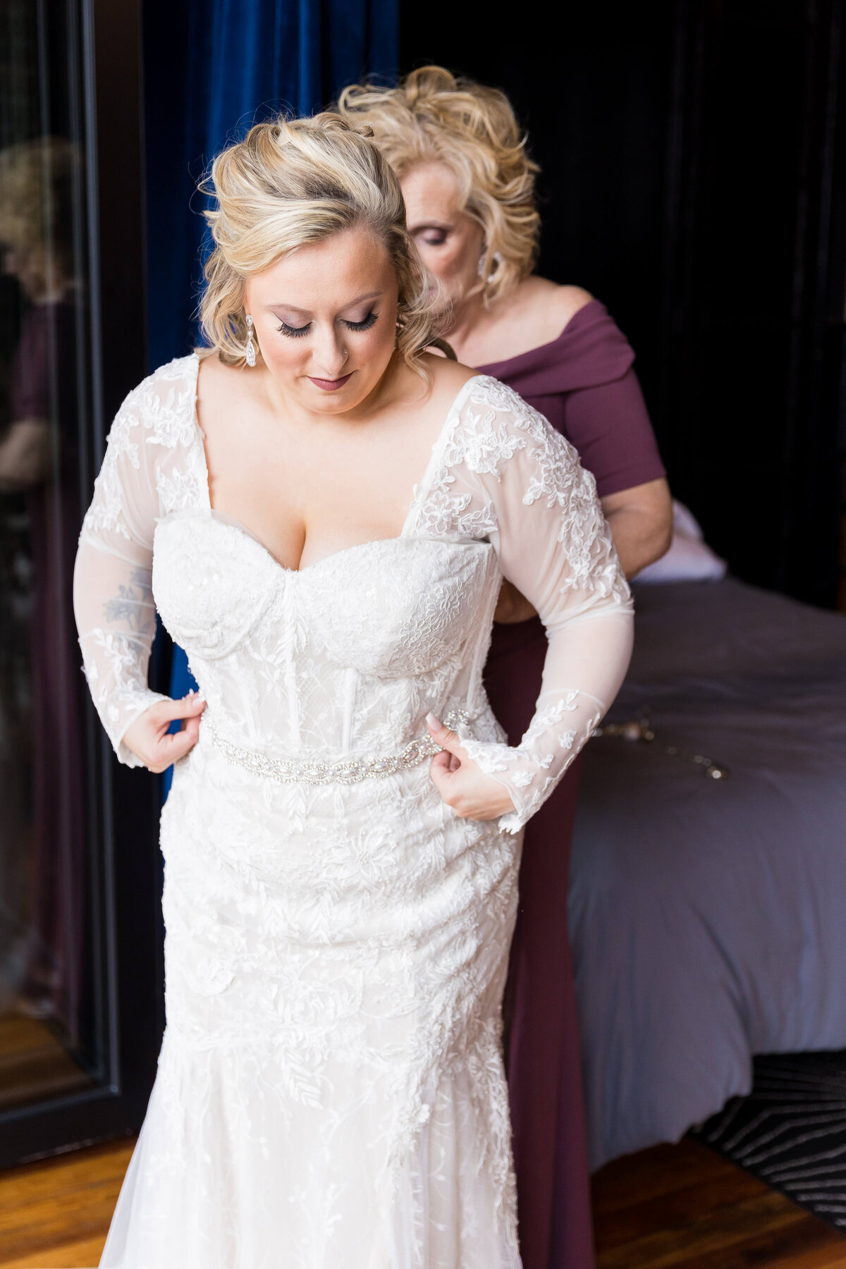 Bride having dress fixed by mother at wedding at  The Gatsby in Shelbyville,KY