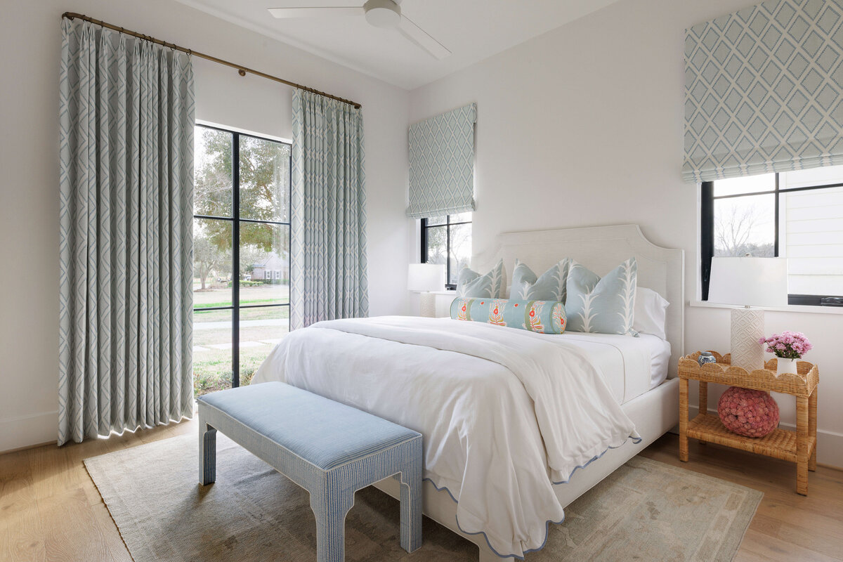 oyster creek studios missouri city new build light blue stool with white bed and wicker bedside table in bedroom