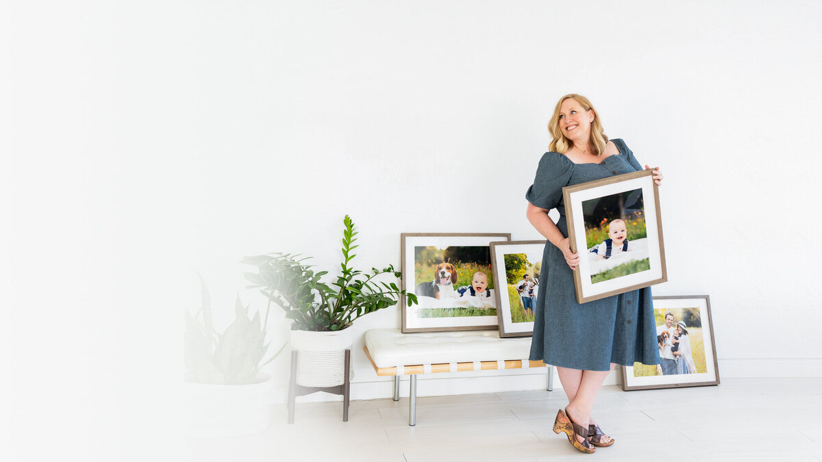 Boise, ID Photographer Tiffany Hix holding a framed portarit in her studio